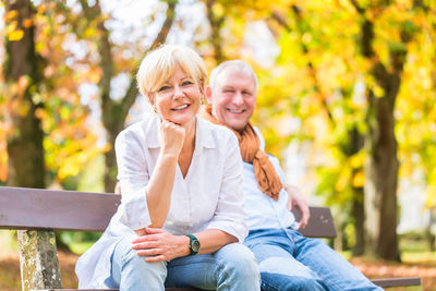 Portrait of smiling woman sitting outdoors