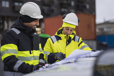 Construction engineers discussing project at construction site