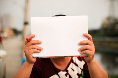 Midsection of woman holding smart phone