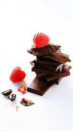 Chocolate cake on plate against white background