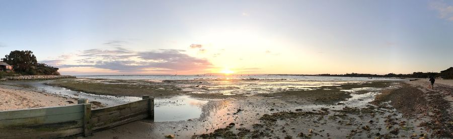 Scenic view of beach against sky during sunset