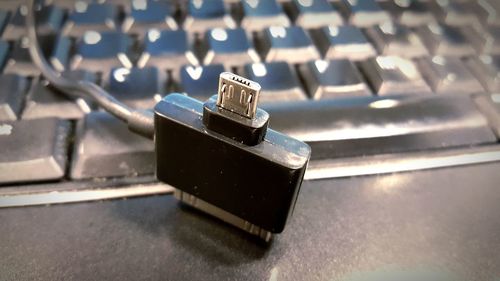 Close-up of network connection plug by keyboard on table