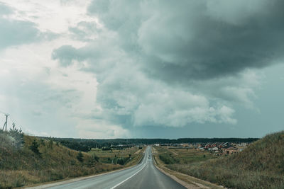 Country road against sky