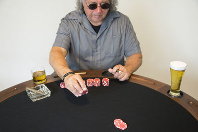 Man playing poker while sitting at table