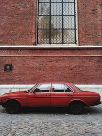 Vintage car on street against building