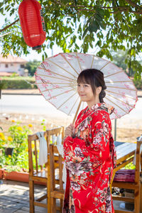 Woman holding red umbrella