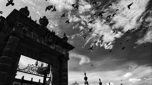 Low angle view of people against sky