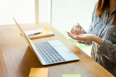 Woman using laptop on table