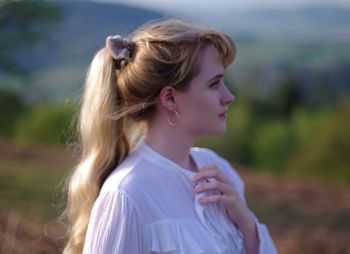 Portrait of young woman looking away outdoors