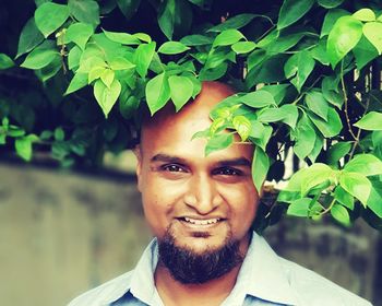 Portrait of young man against plants