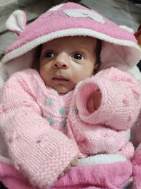 Portrait of cute baby girl with pink hat