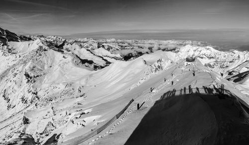 High angle view of snowcapped mountains against sky