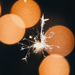 Close-up of illuminated orange against black background