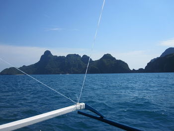 Sailboat on sea against blue sky