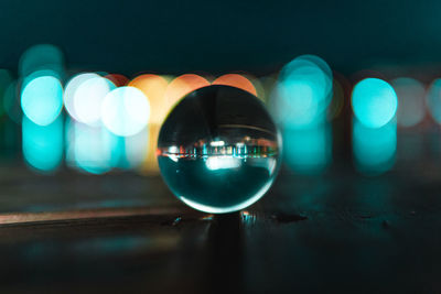 Close-up of illuminated crystal ball on table