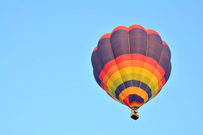 Low angle view of hot air balloon against blue sky