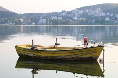 Boats moored in lake against sky