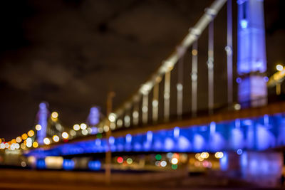 Close-up of illuminated bridge against sky at night