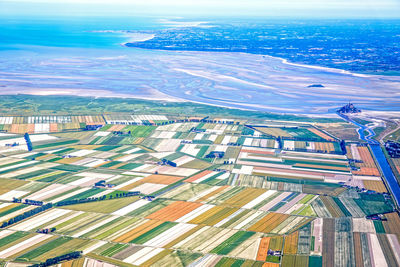 High angle view of city by sea against sky