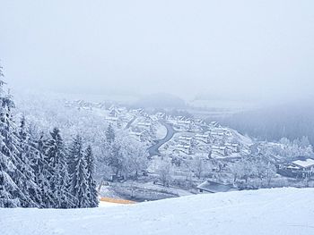 Snow covered landscape against sky