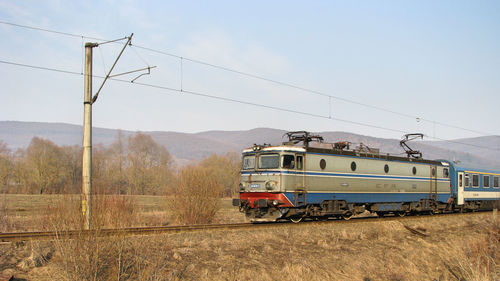 Train on railroad track against sky