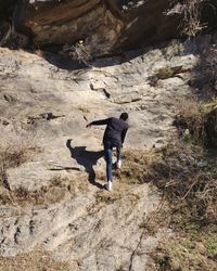 Rear view of man on rock