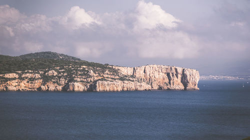 Scenic view of sea and mountains against sky