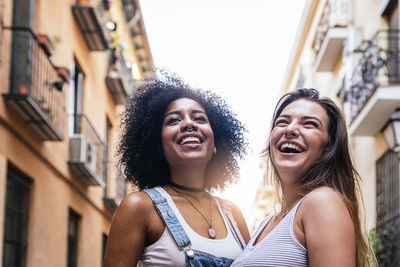 Portrait of smiling young woman in city