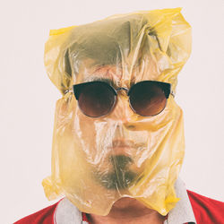 Close-up of man wearing plastic bag on head