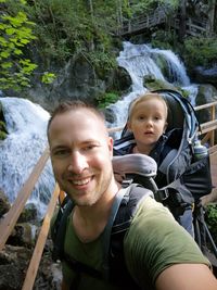 Portrait of smiling man and woman in forest