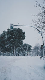 Snow covered street against sky