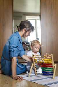 Boy playing with abacus at home