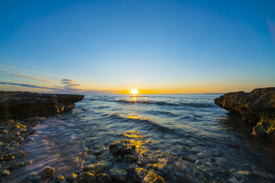 Scenic view of sea against sky during sunset