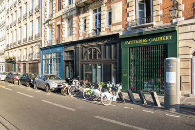 Bicycles on road by buildings in city