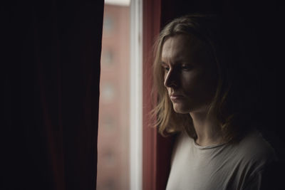 Thoughtful man looking through window