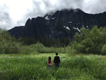 People sitting on grassy field