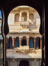 Photograph of window at city palace udaipur. indian architecture.