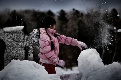 Woman standing on snow covered landscape