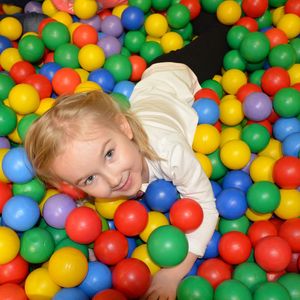 High angle portrait of girl playing with multicolored balls