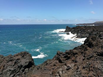 Scenic view of sea against blue sky