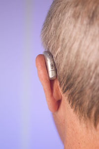 Close-up portrait of man against blue background