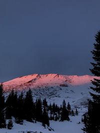 Scenic view of snowcapped mountains against sky during winter