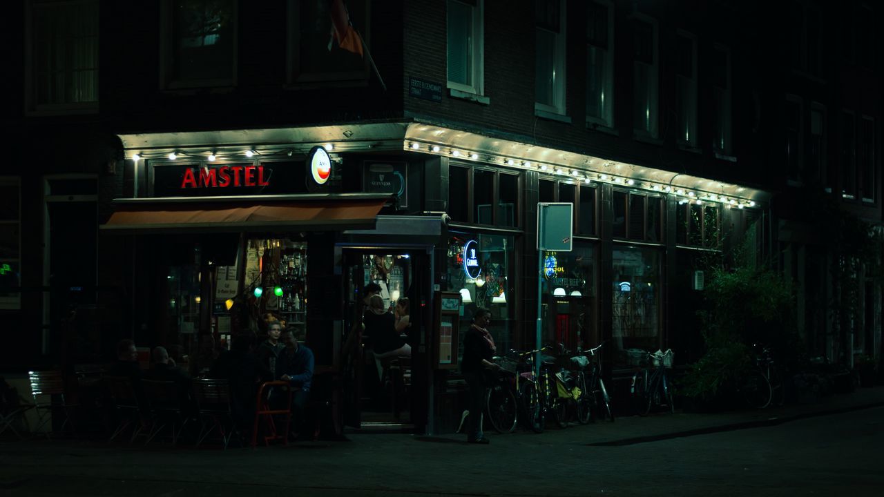 night, architecture, illuminated, city, building exterior, built structure, group of people, restaurant, text, street, real people, incidental people, communication, food and drink, city life, women, sign, lifestyles, neon, store, nightlife, outdoors, store sign