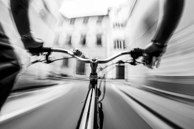 Blurred motion of person riding bicycle in city