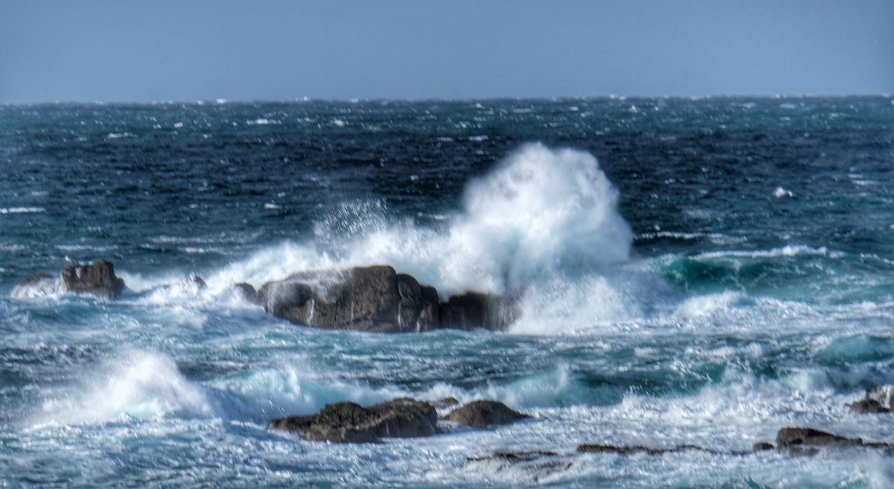 WAVES SPLASHING ON ROCKS