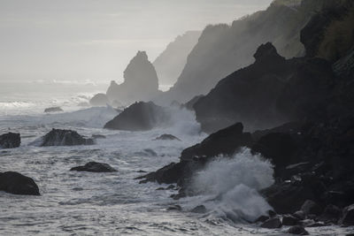 Waves splashing on rocks at shore