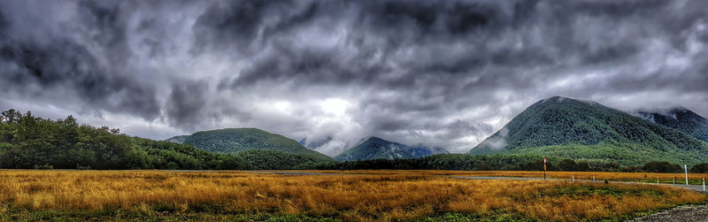 Panoramic view of landscape against storm clouds