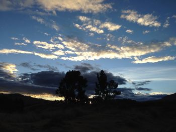 Scenic view of mountains against cloudy sky