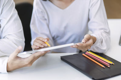 Midsection of man working on table