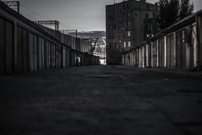 Walkway in city against sky